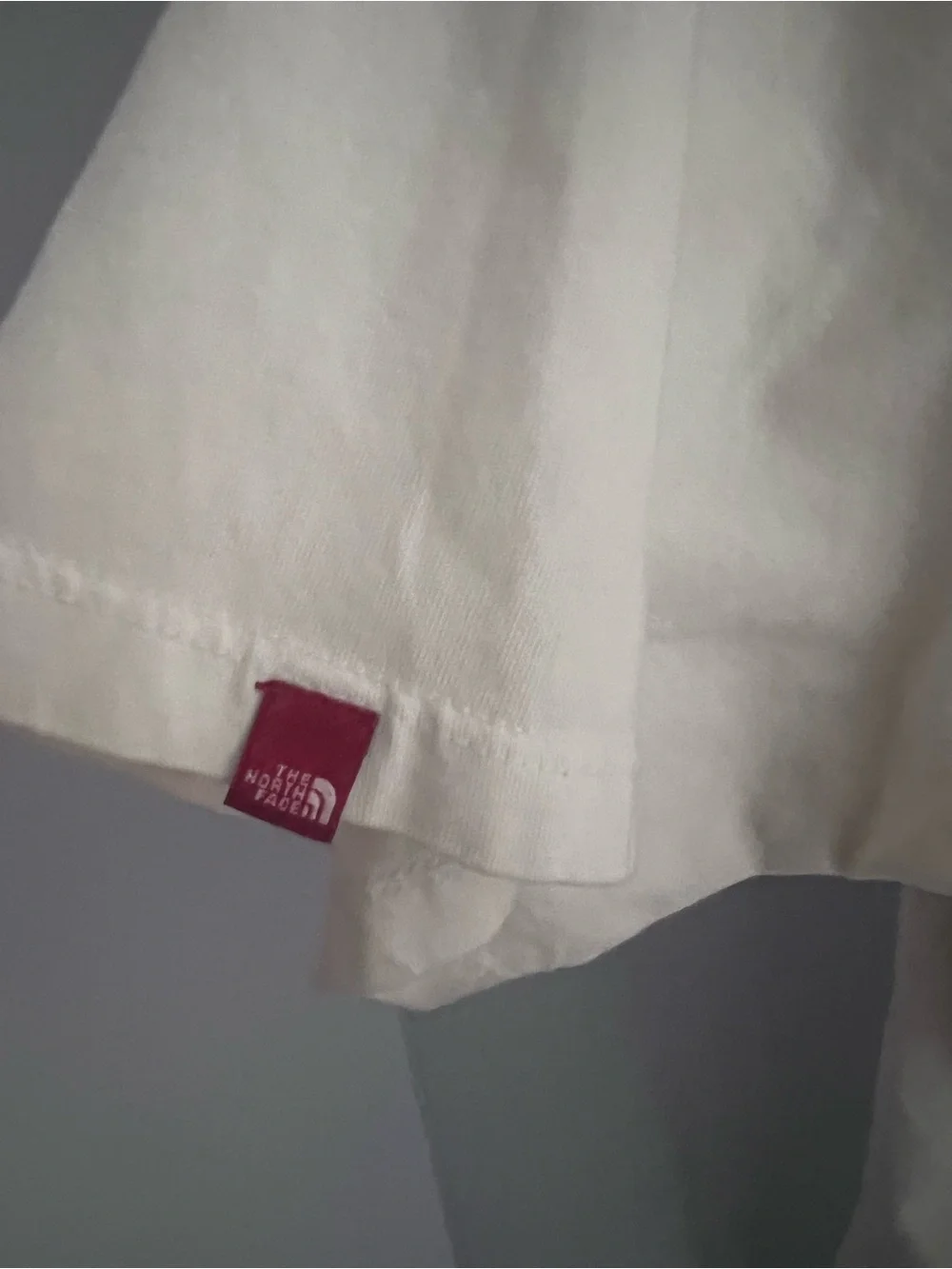 The North Face Men's off white/ cream colored Polo with Red Collar Trim